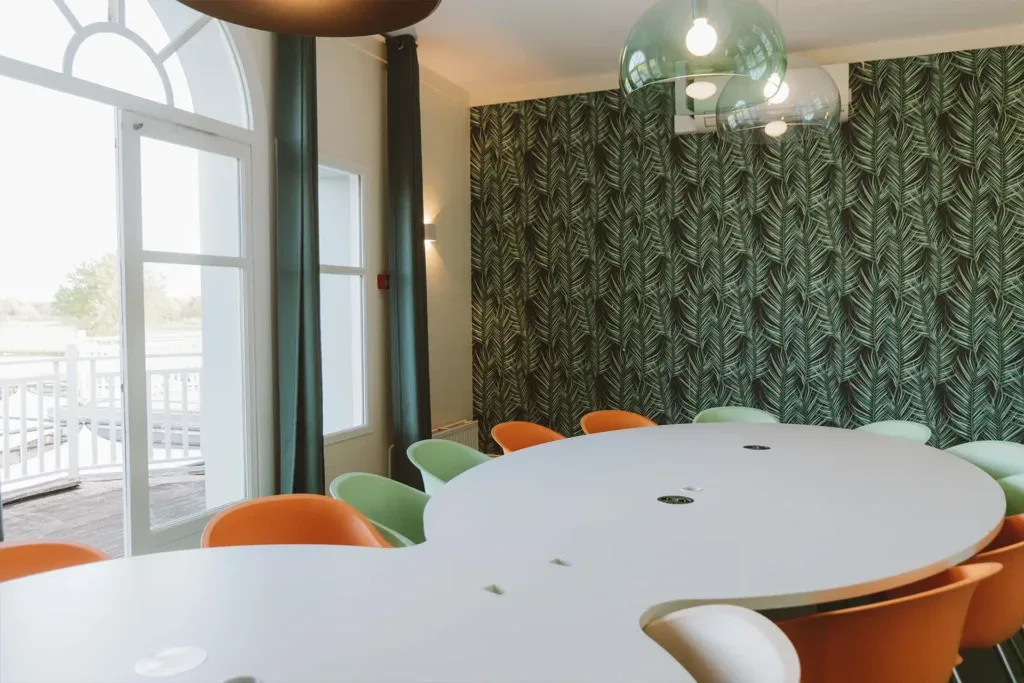 Salle de réunion avec décor végétal et fauteuils colorés